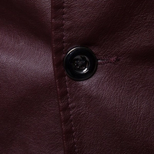 Detail of burgundy PU leather jacket with premium litchi texture and neat stitching