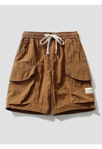 Detail of cargo shorts waist with white drawstring and elastic band on nylon fabric