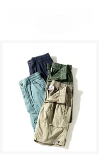 Flat lay of multi-color cargo shorts in navy, green, blue, and khaki cotton fabric