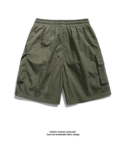 Detail of army green cargo shorts featuring elastic waist and quick-dry fabric texture