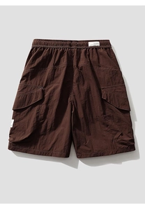 Detail of cargo shorts showing elastic waistband and large side flap pockets in dark brown