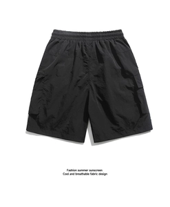 Detail of black cargo shorts featuring elastic waistband and breathable tech fabric