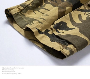 Detailed close-up of double-stitched hem and camouflage print on men's cargo shorts