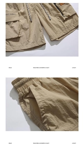 Detail of khaki cargo shorts showing elastic waist, drawstring, and side flap pocket