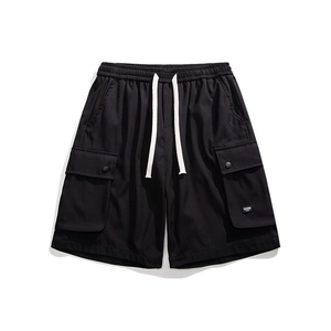 Flat lay of men's black cargo shorts with white drawstring and side utility pockets