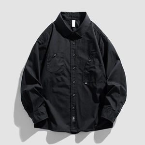 Classic black utility long-sleeve shirt featuring asymmetric pockets and high-density cotton