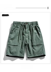 Detailed flat lay of army green cargo shorts with drawstring waist and tactical pockets