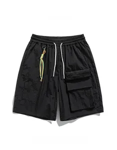 Detail of black utility shorts featuring tactical pockets and white drawstrings