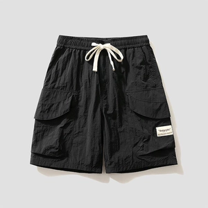 Men's black cargo shorts with elastic waist and white drawstrings in a flat lay view