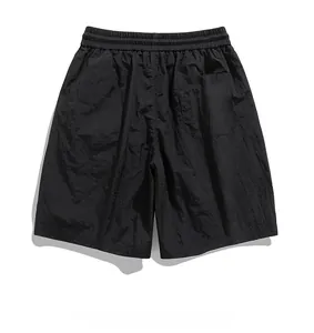 Detail of black ice silk shorts showing elastic drawstring waist and nylon fabric texture