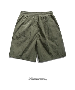 Detail of olive green cargo shorts featuring elastic waistband and quick-dry textured fabric