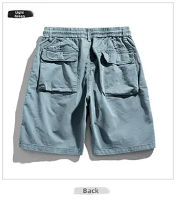 Detail view of the back of light green cargo shorts featuring oversized flap pockets