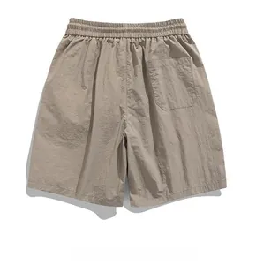Detail of khaki ice silk shorts featuring elastic drawstring waist and textured fabric