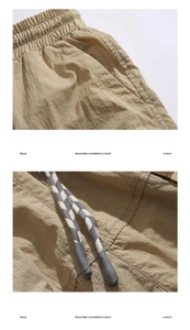 Detail of khaki cargo shorts showing ripstop fabric texture and braided drawstring