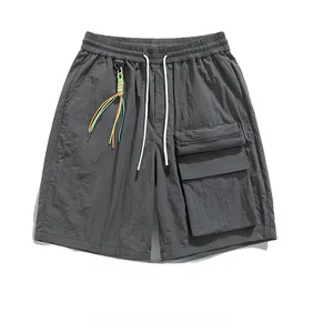 Macro shot of dark grey cargo shorts featuring utility pockets and colorful drawstring