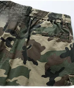 Detail of jungle camouflage cargo pants with drawstring waist and back welt pocket
