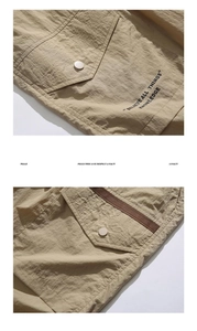 Detail of khaki cargo shorts with ripstop fabric and metal buckle pockets