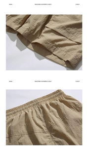 Detailed close-up of khaki cargo shorts showing elastic waist and ripstop fabric texture