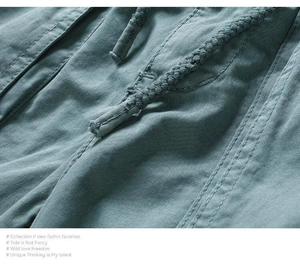 Macro detail of casual shorts showing cotton fabric texture and braided drawstring cord