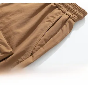Detail view of khaki ice silk cargo shorts showing elastic waist and fine twill texture