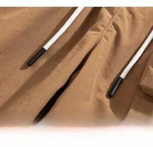 Close-up of elastic waistband with black and white braided drawstring on cargo shorts