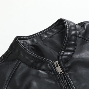 Detail of black motorcycle jacket showing the stand collar stitching and metal zipper