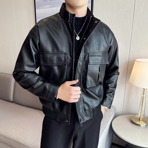 Close-up of black PU leather motorcycle jacket with utility flap pockets and ribbed hem