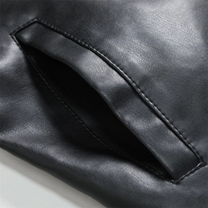 Detail shot of the black matte leather biker jacket featuring a side pocket and stitching