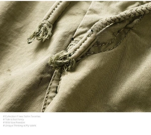 Close-up of military green twill cotton fabric with durable drawstring detail on shorts