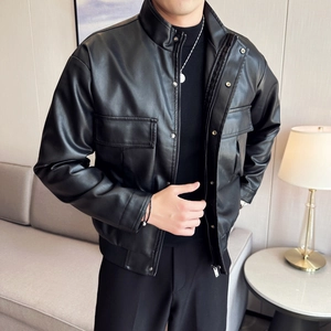 Detail of black leather motorcycle jacket featuring standing collar and front flap pockets