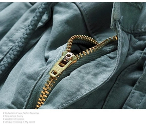 Detailed macro view of the gold metal YEK zipper on Japanese-style cargo pants