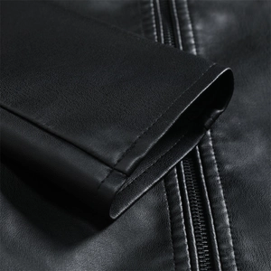 Macro shot of sleeve cuffs and metal zipper details on a black leather jacket