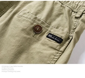 Close-up of khaki cargo pants back pocket with button detail and woven brand label