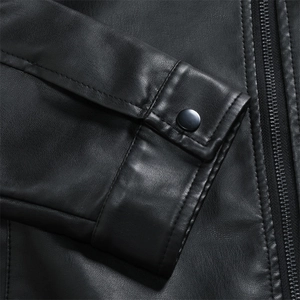 Detail of matte black snap button and textured PU leather grain on the motorcycle jacket
