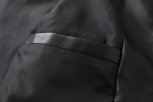 Macro shot of the neat stitching on the inner pocket of a black PU leather jacket