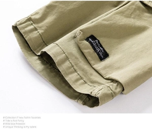Close-up of khaki cotton twill fabric with decorative side label and neat hem stitching