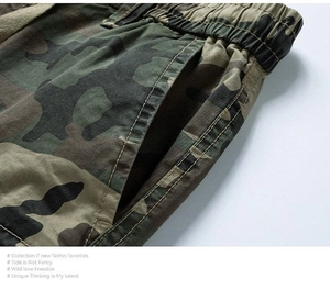 Detail of camouflage cargo shorts featuring elastic waist and reinforced double stitching