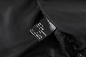 Detail view of inner wash label showing material composition for the men PU leather jacket