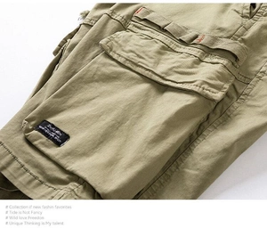 Detail of army green cargo pants featuring reinforced seams and ZMIYU-JEN woven label