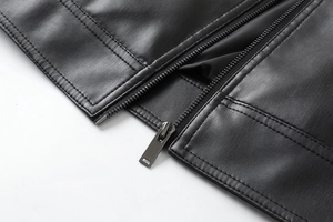Close-up of high-quality black PU leather jacket hem with durable metal zipper details