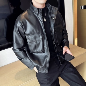Detailed view of the black faux leather jacket texture with industrial flap pockets