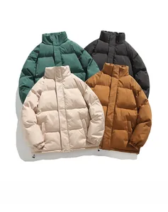 Flat lay of men's winter puffer jackets in multiple colors including black and green