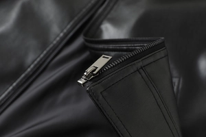 Close-up of premium black PU leather jacket showing metallic zipper and fine stitching detail