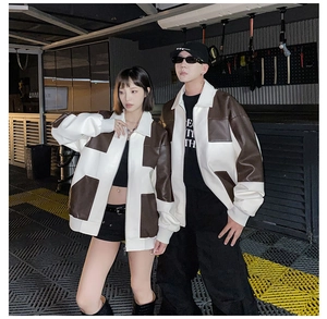 Dettaglio della giacca patchwork in pelle PU marrone e bianca con colletto per coppie