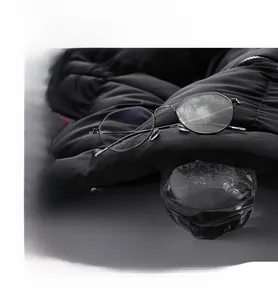 Macro shot demonstrating breathable black down jacket fabric with steam rising through the lens