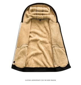 Detail view of thick beige sherpa lining inside the black hooded jacket for warmth