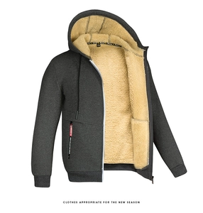 Detail of warm beige lamb wool lining and zipper on dark grey men hooded jacket
