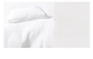 Detailed close-up of precise straight stitching on high-quality white fabric garment