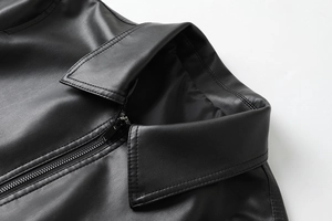 Detailed macro view of the matte PU leather collar and zipper on the black jacket