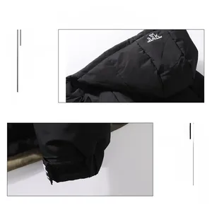 Detail of hooded black winter jacket featuring adjustable velcro cuffs and GAIE 32K printed logo
